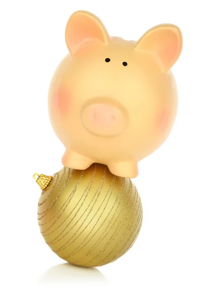 Piggy bank balancing on a Christmas ball — Stock Photo, Image