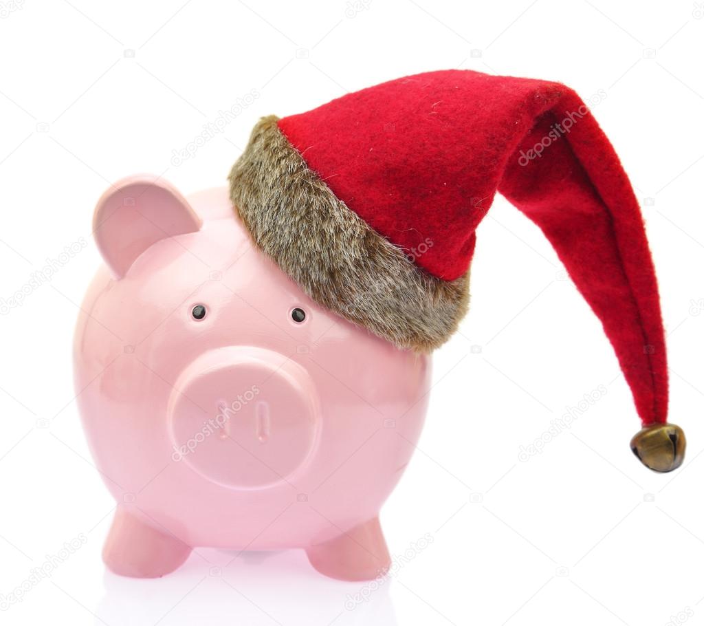Piggy bank with Santa Claus hat on white background