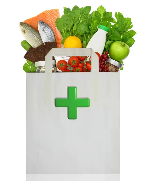 Bolsa de papel con cruz verde médica llena de alimentos saludables — Foto de Stock