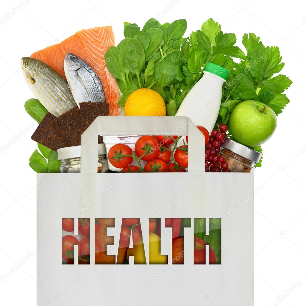 Paper bag full of healthy foods isolated on white