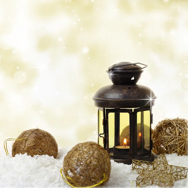 Christmas lantern and ornaments on snow — Stock Photo, Image