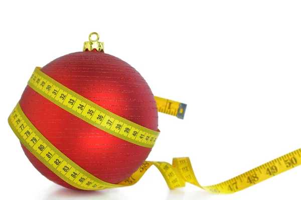 Christmas ball with measuring tape isolated on white — Stock Photo, Image