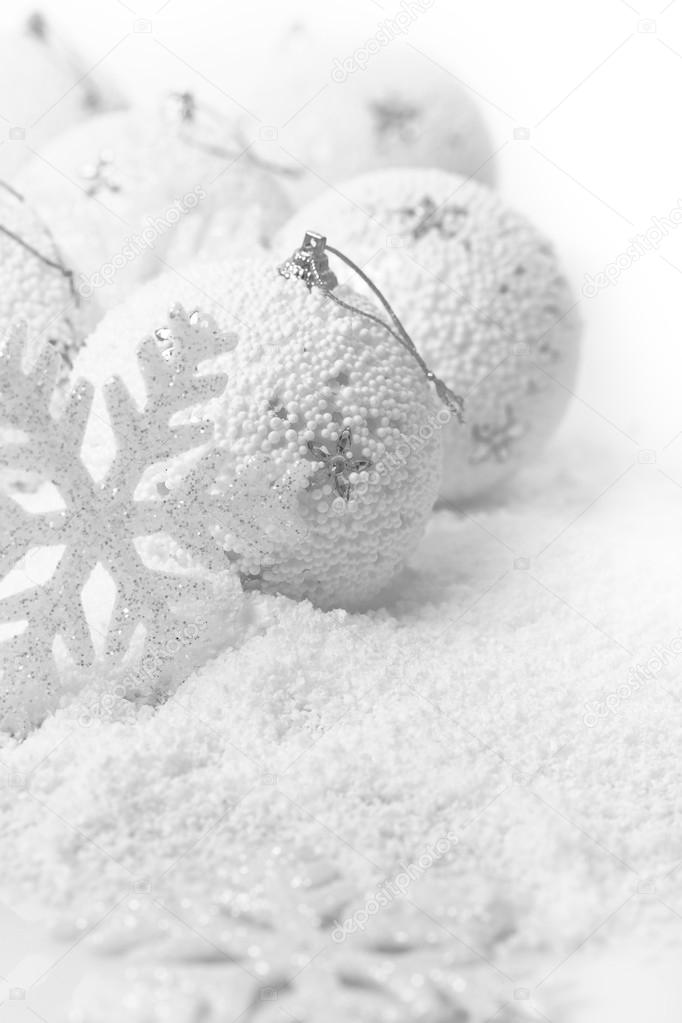Christmas ornaments on white snowy background