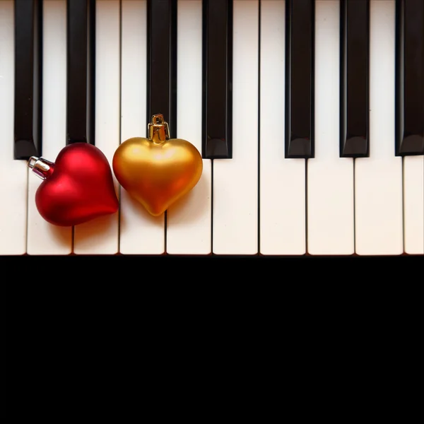 Christmas ornaments on piano keys — Stock Photo, Image