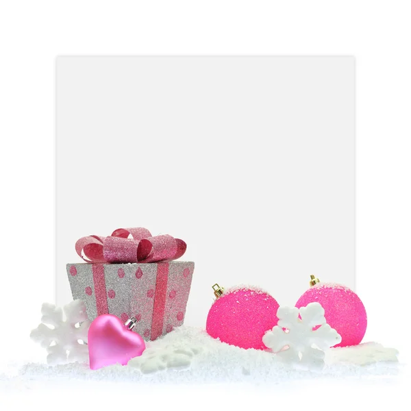 Caixa de presente e enfeites de Natal rosa na frente de um cartão de papel — Fotografia de Stock