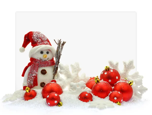 Snowman and Christmas ornaments in front of a paper card — Stock Photo, Image