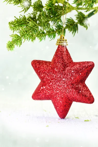 Christmas ornament red star on tree branch — Stock Photo, Image
