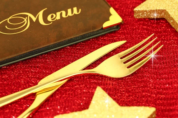 Christmas golden cutlery and restaurant menu on festive background — Stock Photo, Image