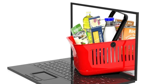 Shopping hand basket full with products on laptop, isolated — Stock Photo, Image