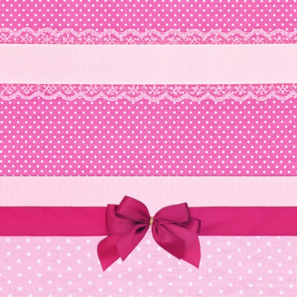 Pink retro polka dot textile background with ribbons and bow — Stock Photo, Image