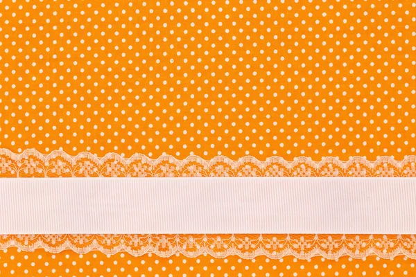 Orange retro polka dot textile background with ribbon — Stock Photo, Image