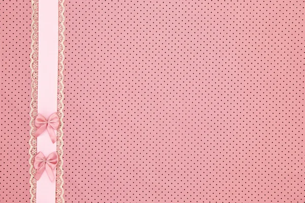 Pink polka dot textile background with ribbon and bows — Stock Photo, Image