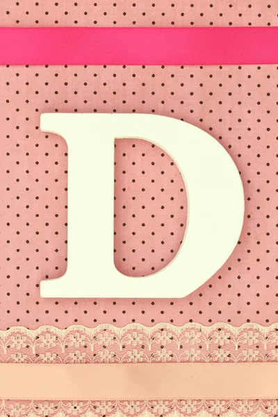 Wooden letter D on polka dots background — Stock Photo, Image