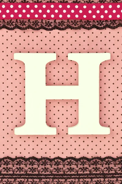 Wooden letter H on polka dots background — Stock Photo, Image