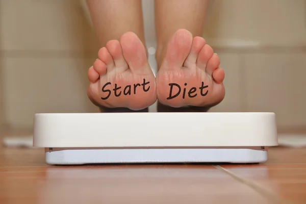 Feet on bathroom scale with hand drawn Start Diet text — Stock Photo, Image