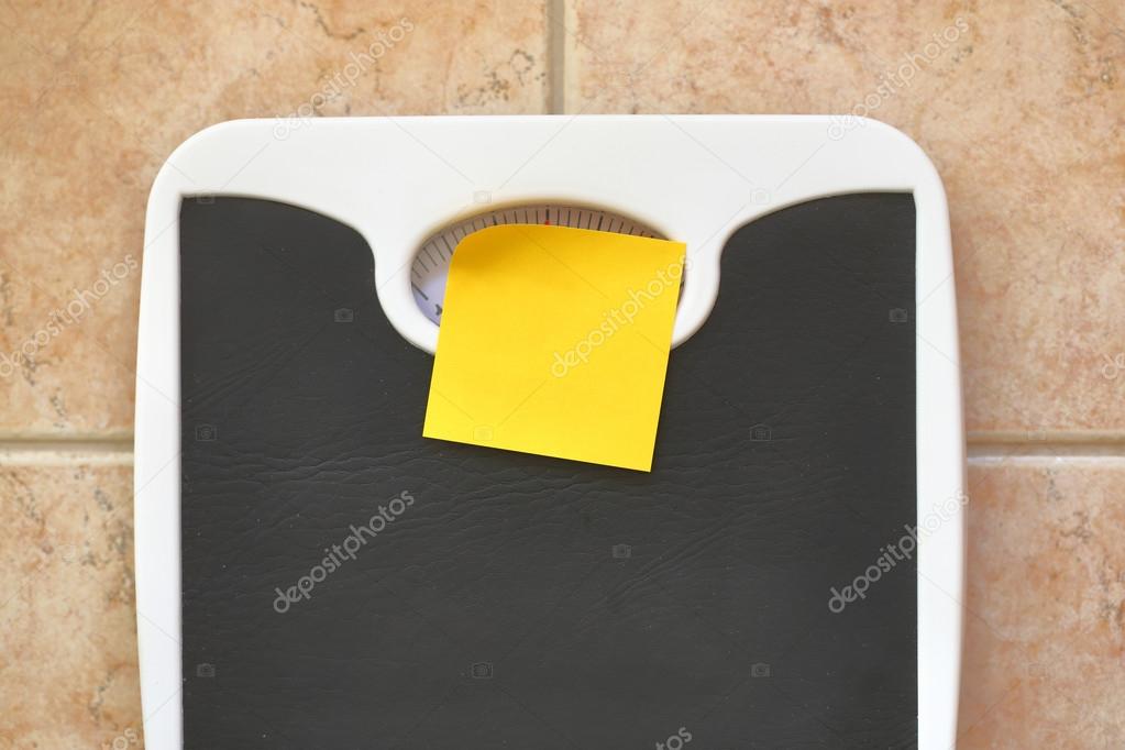 Bathroom scale with blank memo sticker. Diet and fitness concept