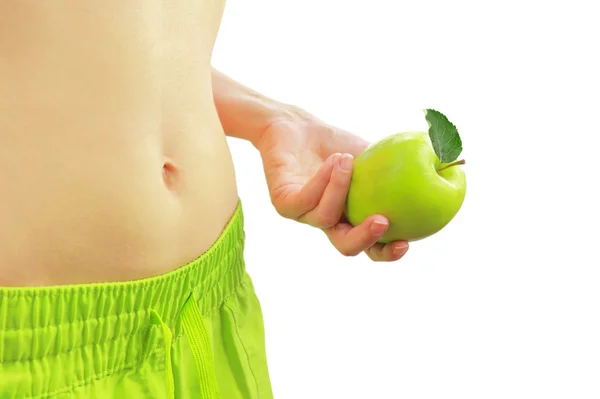 Γυναίκα που κρατά το πράσινο μήλο δίπλα ταιριάζει κοιλιά της, που απομονώνονται σε λευκό — Φωτογραφία Αρχείου