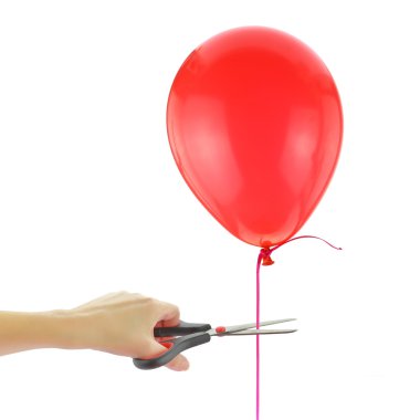 Scissors about to cut loose a balloon isolated on white clipart