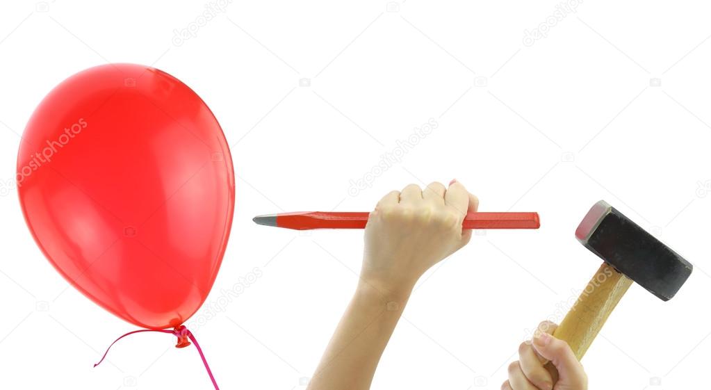chisel and hammer about to pop a balloon isolated on white stock