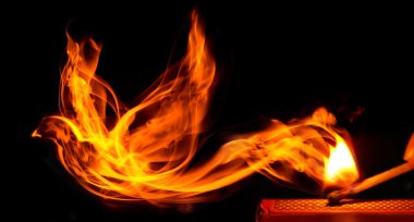 Bird made of fire comes from a burning matchstick clipart