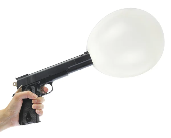 Hand holding gun with balloon isolated on white — Stock Photo, Image