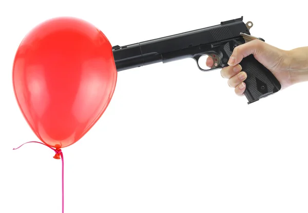 Hand holding at gunpoint a red balloon isolated on white — Stock Photo, Image