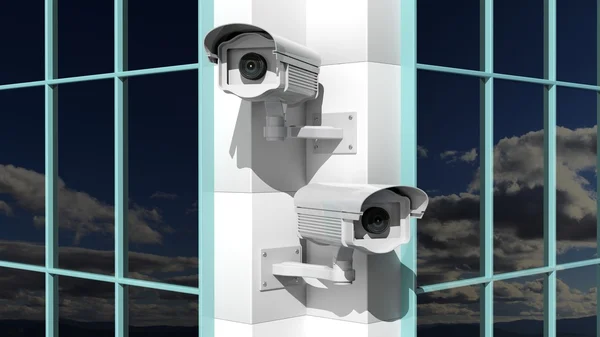 Two security surveillance cameras on skyscraper building — Stock Photo, Image