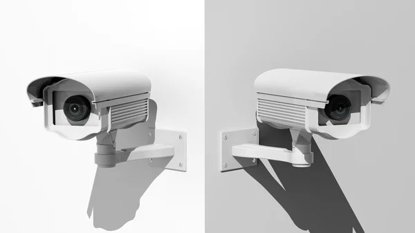 Two security surveillance cameras on white wall corner — Stock Photo, Image