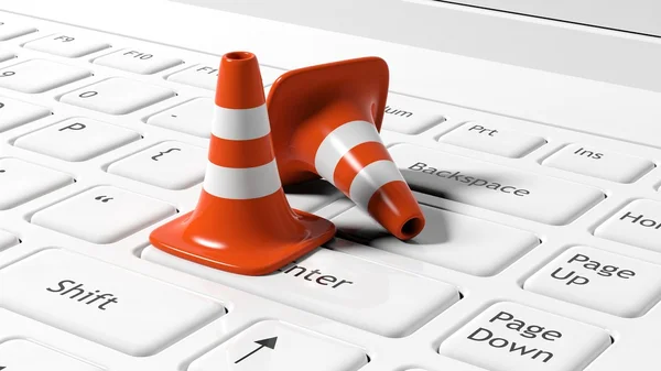 Orange traffic cones on white laptop keyboard — Stock Photo, Image