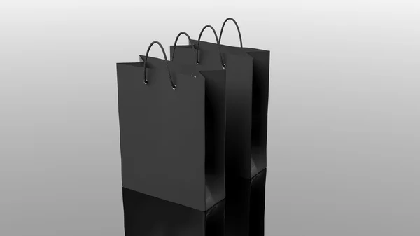 Twee zwarte papieren winkelen zakken met reflectie — Stockfoto
