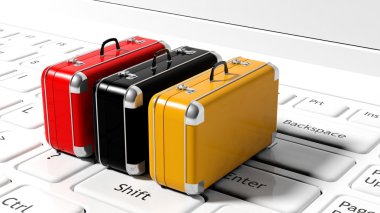 Colorful suitcases on white laptop keyboard clipart