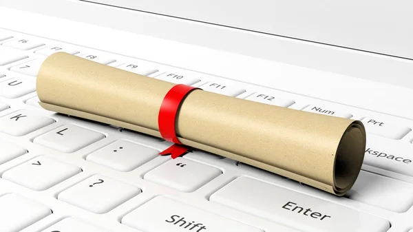 Scroll with red ribbon on laptop keyboard. — Stock Photo, Image