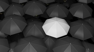Classic large black umbrellas tops with one white standing out. clipart