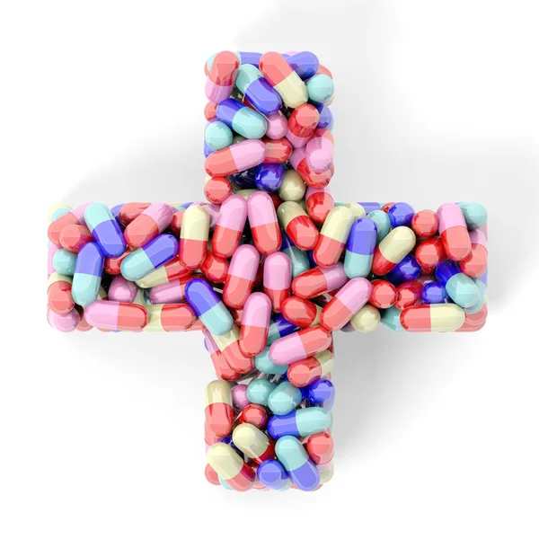 Colorful caplets in shape of medical cross, isolated on white background. — Stock Photo, Image