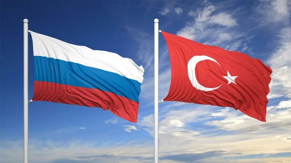 Турецька та російська прапори проти синього неба — стокове фото