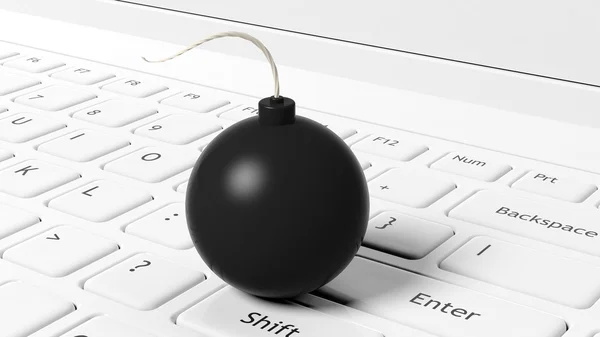 Black cannonball bomb on white laptop keyboard. — Stock Fotó