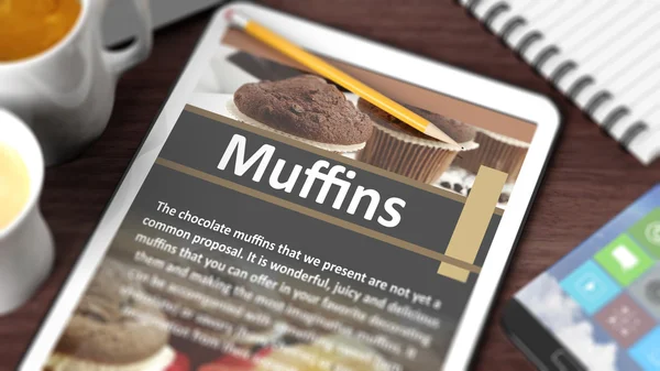 Table avec divers objets axés sur la tablette avec la recette de "Muffins" à l'écran — Photo