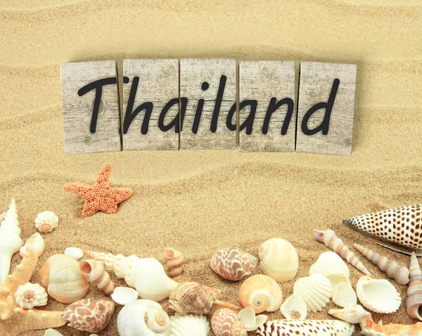 Thailand on wooden board pieces with sea shells and sand — Stock Photo, Image