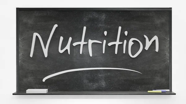 Nutrition written on blackboard — Stock Photo, Image