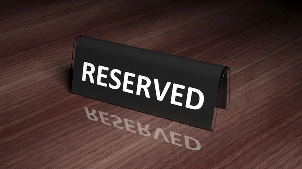 Black glossy reservation sign on wooden surface with reflection — Zdjęcie stockowe