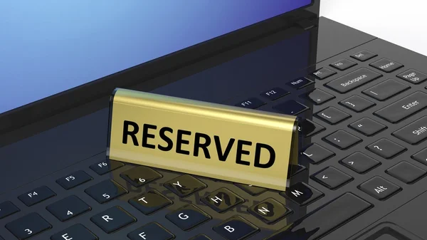 Golden glossy reservation sign on laptop keyboard, isolated on white background. — 스톡 사진