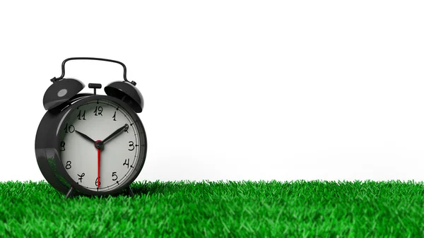 Retro black alarm clock on grass, isolated on white background. — Stock Photo, Image