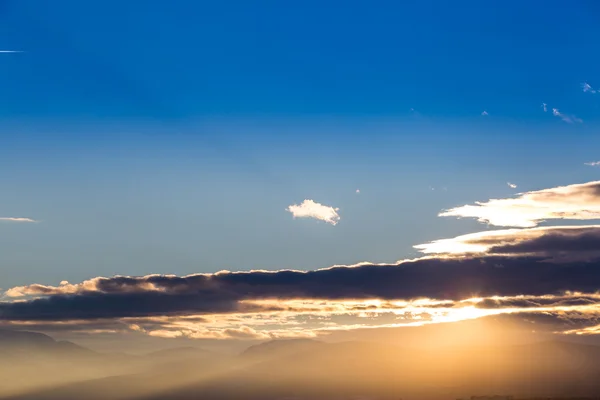 Sunset with orange and blue sky above ground, aerial shot. — Stock Photo, Image