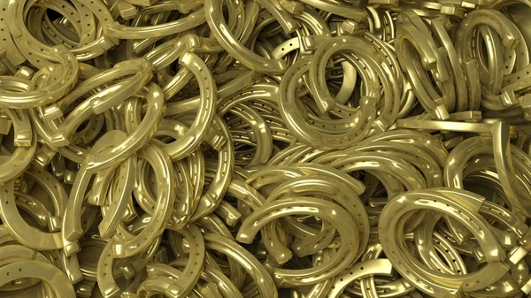 Golden horseshoe pile abstract background. — Stockfoto