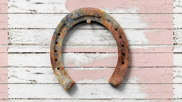 Old rusty horseshoe, set on wooden surface — Stock Photo, Image