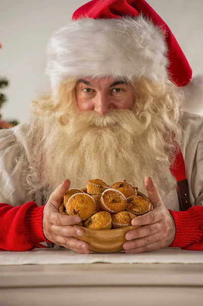 Santa Claus holding cookie — Stock Photo, Image