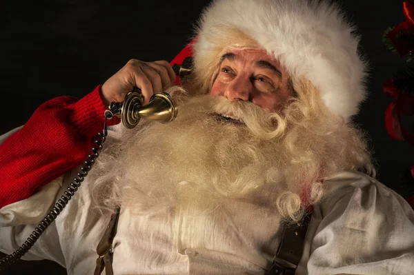 Santa Claus calling phone at home — Stock Photo, Image