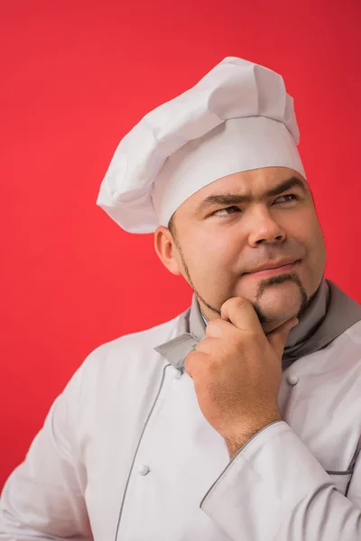 Człowiek w jednolite myślenie szefa kuchni — Zdjęcie stockowe