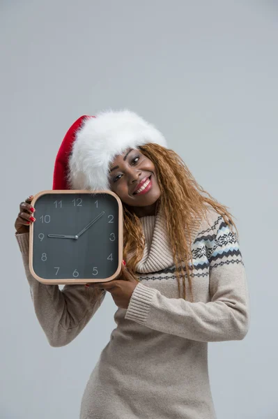 Young african woman with clock looking at camera — Stock Photo, Image