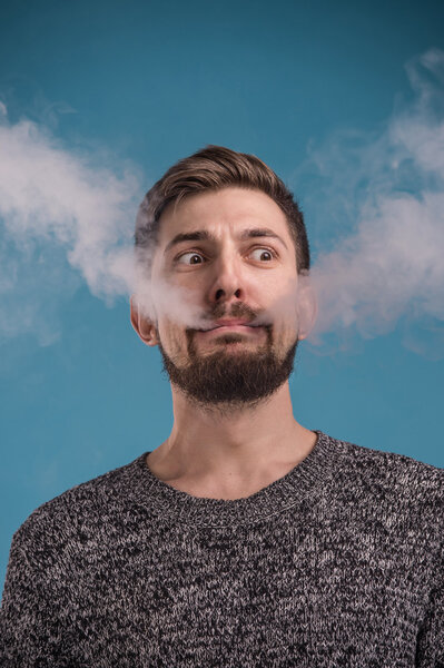 Expressive man vaping 